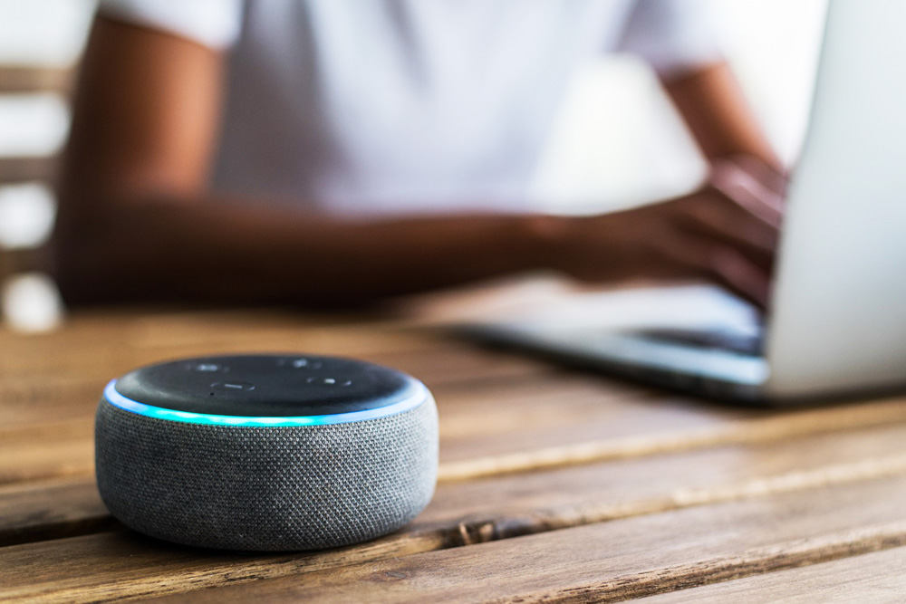 Technician inspecting industrial gears and mechanical spare parts on a workbench.